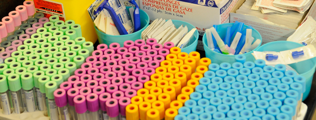 Medical vials in different colours, neatly placed in a cart